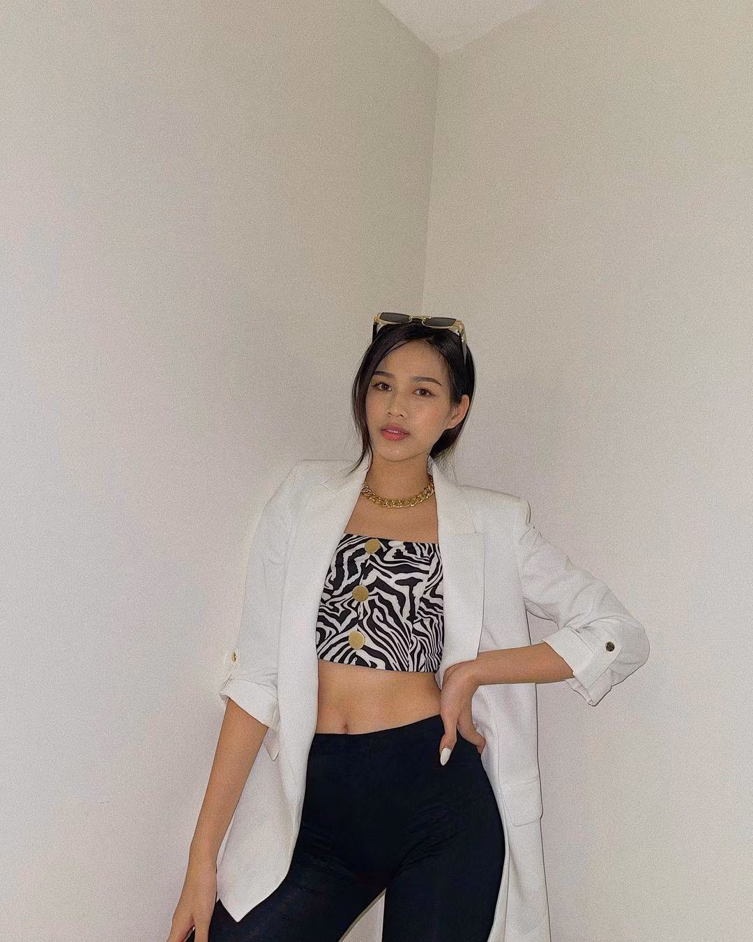Áo crop-top hoạ tiết lạ mắt được Đỗ Thị Hà phối cùng áo blazer trắng mang lại một tổng thể sành điệu và quyến rũ.