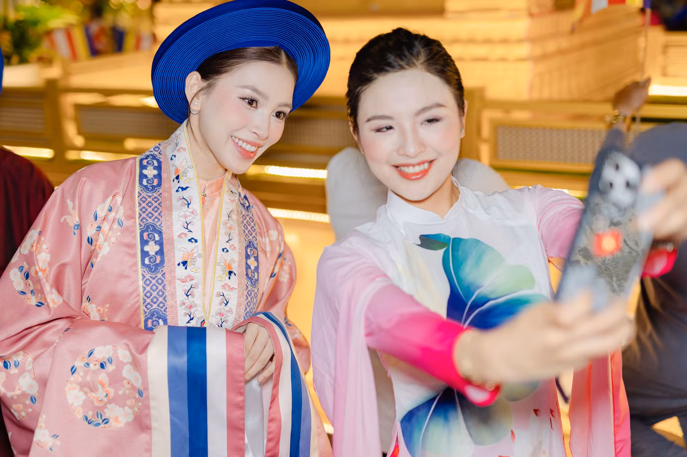 Hoa hậu Việt Nam 2018 Trần Tiểu Vy mặc Việt phục với tông màu hồng chủ đạo.