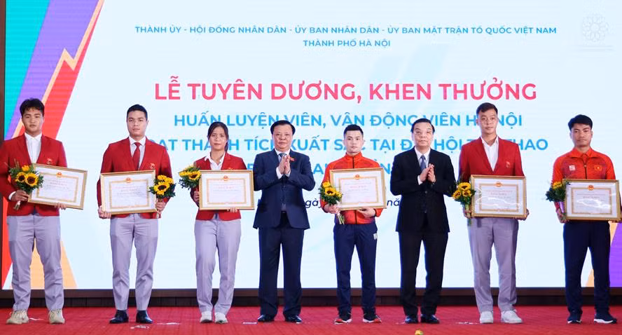 Bí thư Thành ủy Hà Nội Đinh Tiến Dũng, Chủ tịch UBND thành phố Hà Nội Chu Ngọc Anh tặng thưởng các VĐV Hà Nội đạt thành tích cao tại SEA Games 31. Ảnh: PV