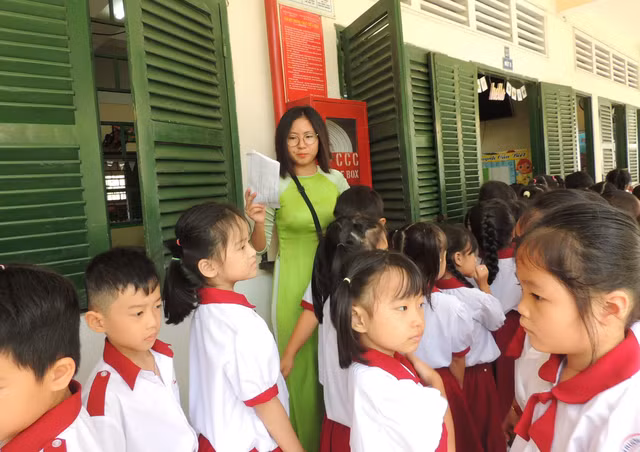 Giáo viên Trường tiểu học Hồng Hà, Bình Thạnh, TPHCM hướng dẫn học sinh lớp 1 làm quen với sinh họat, trường lớp.