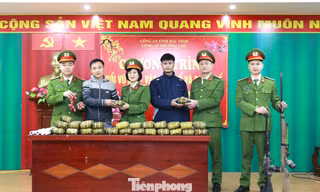 Người dân giao nộp vũ khí nhận quà Tết tại Công an phường Chũ (tỉnh Bắc Ninh).