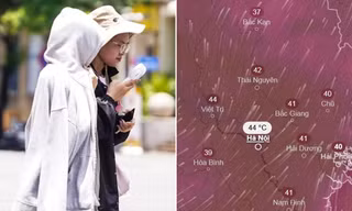 Người dân che nắng khi di chuyển ngoài trời ở Hà Nội