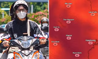Người dân Hà Nội di chuyển trong thời tiết nắng nóng.